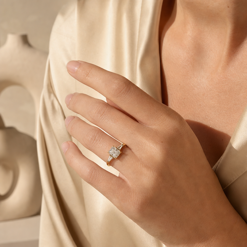 Radiant cut three-stone ring, worn on hand