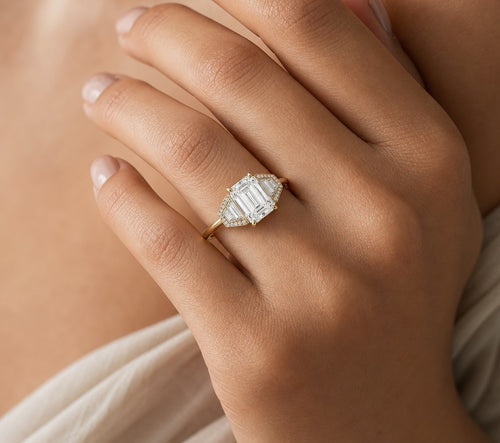 Art deco emerald cut engagement ring, worn on hand