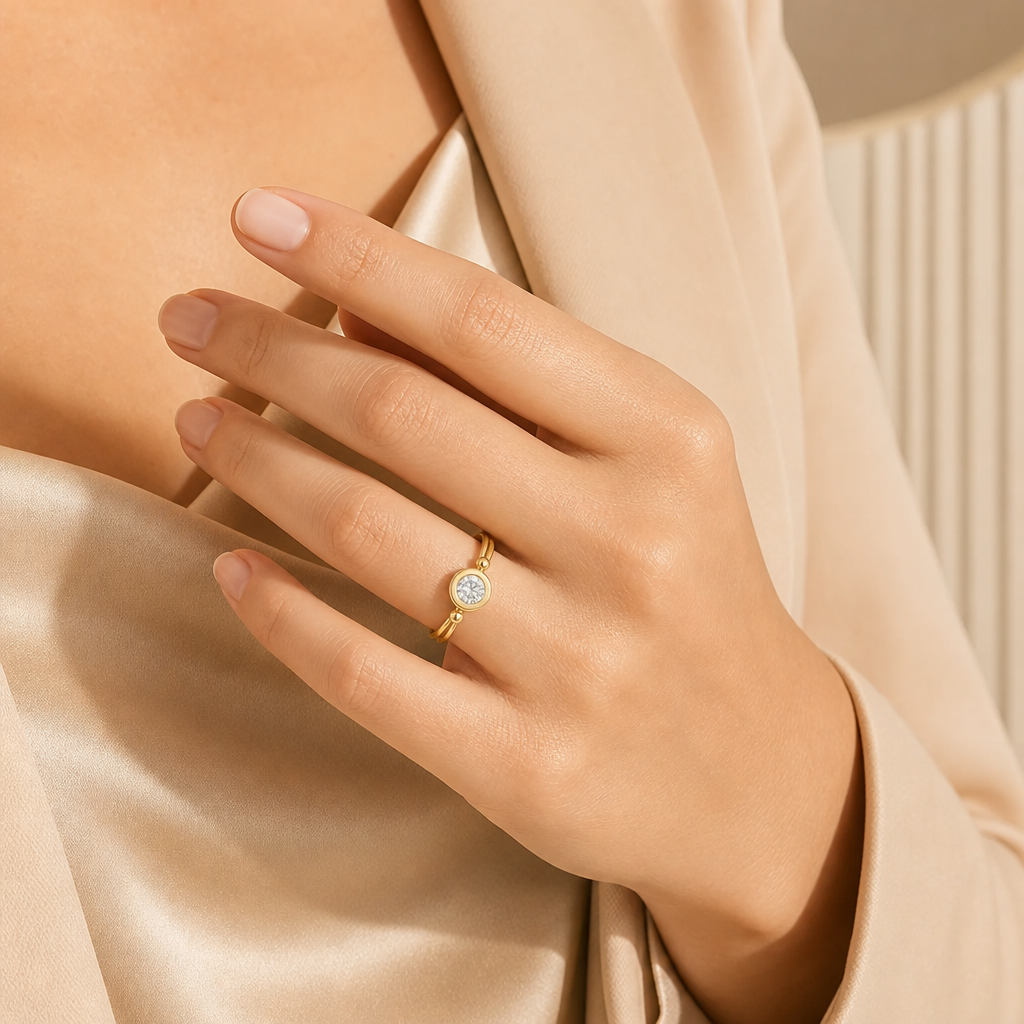 Round bezel solitaire ring, worn on hand